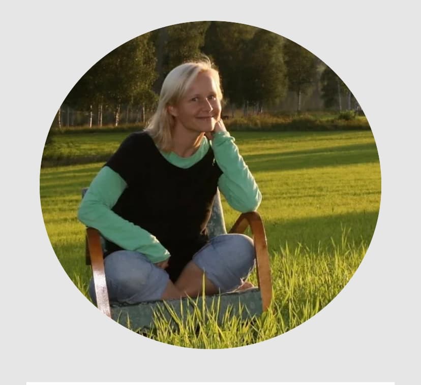 Nilla, facilitator of Her Blessing Circle, sitting in a green field
